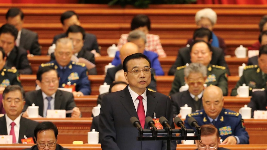 China's Premier Li Keqiang with members of the parliament seated behind at the opening of the National People's Congress.