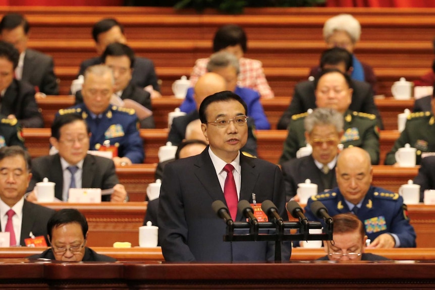 China's Premier Li Keqiang with members of the parliament seated behind at the opening of the National People's Congress.
