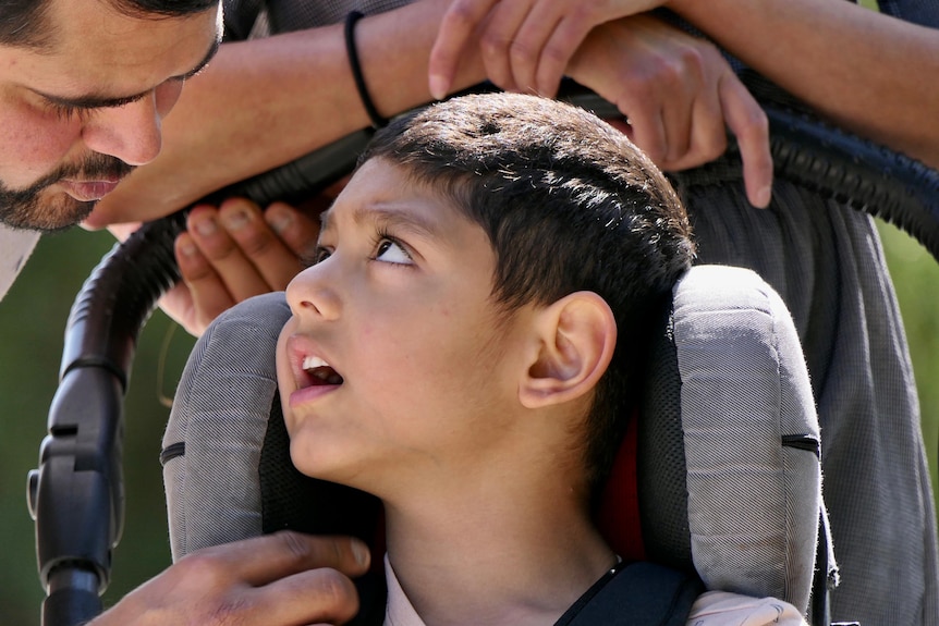 A close up of young boy Kayaan looking up at his father Varun as he speaks to him.