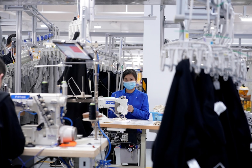  A woman working in a clothing factory. 