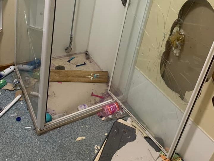 A trashed shower in a social housing unit bathroom