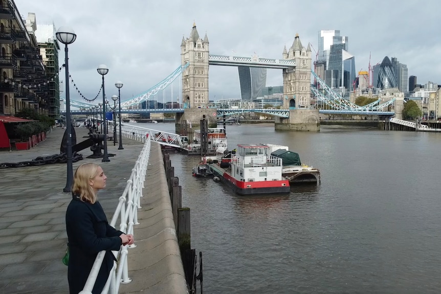 A woman looks across a river.