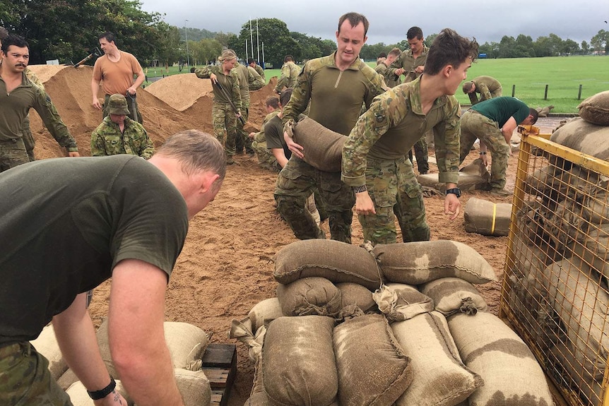 Army personnel fill sandbags in flooded Townsville in north Queensland