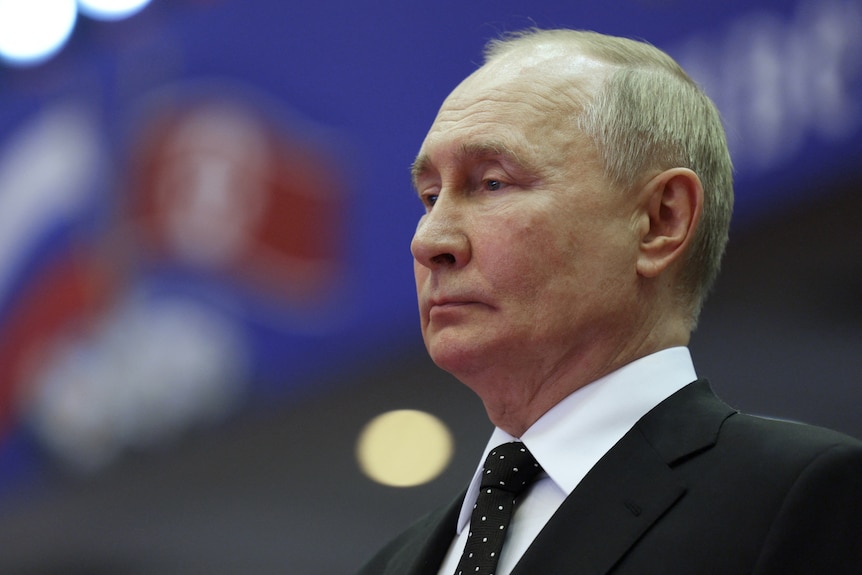 A sad-looking Putin, viewed from the side.