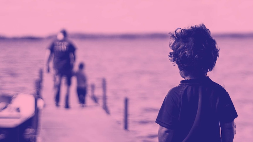 Young boy looks on at a father and a child on a jetty for a story about the effects of not being shown kindness when young.