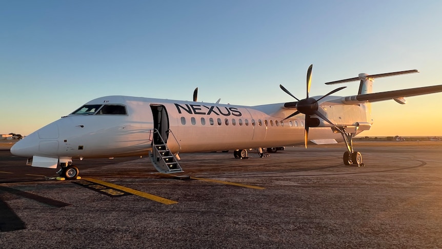 A white Dash 8 aircraft with Nexus written on the side.