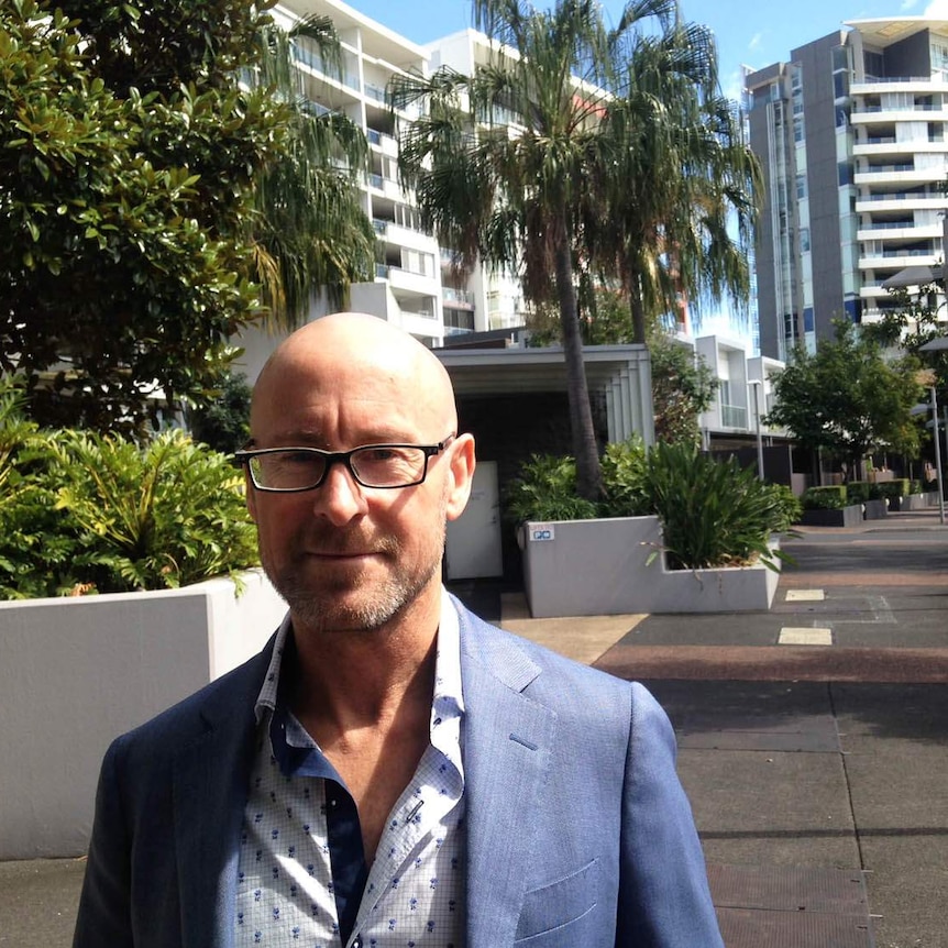 LJ Hooker agent Des Besanko outside inner Brisbane apartments