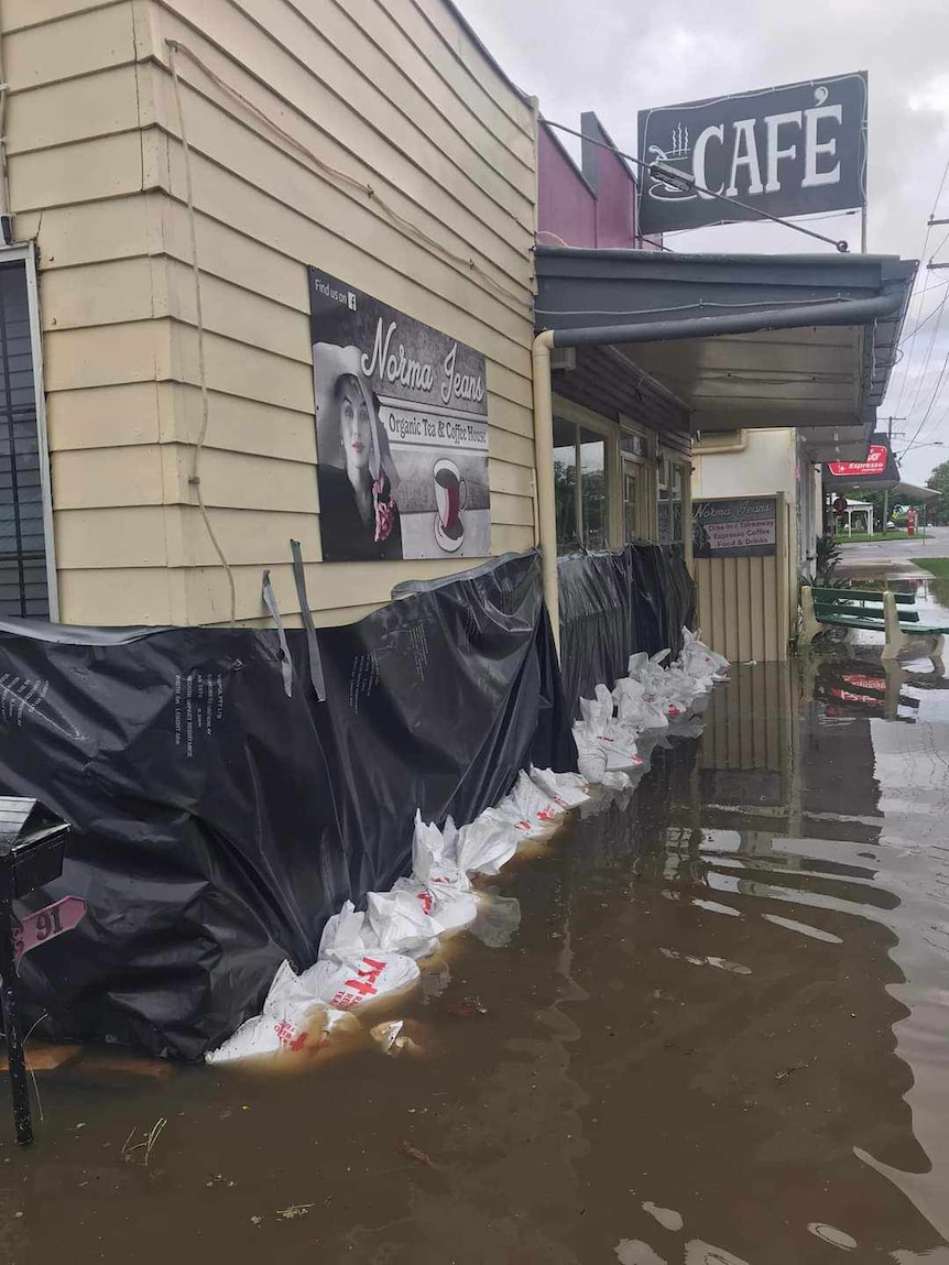 A flooded store protected by sandbags.