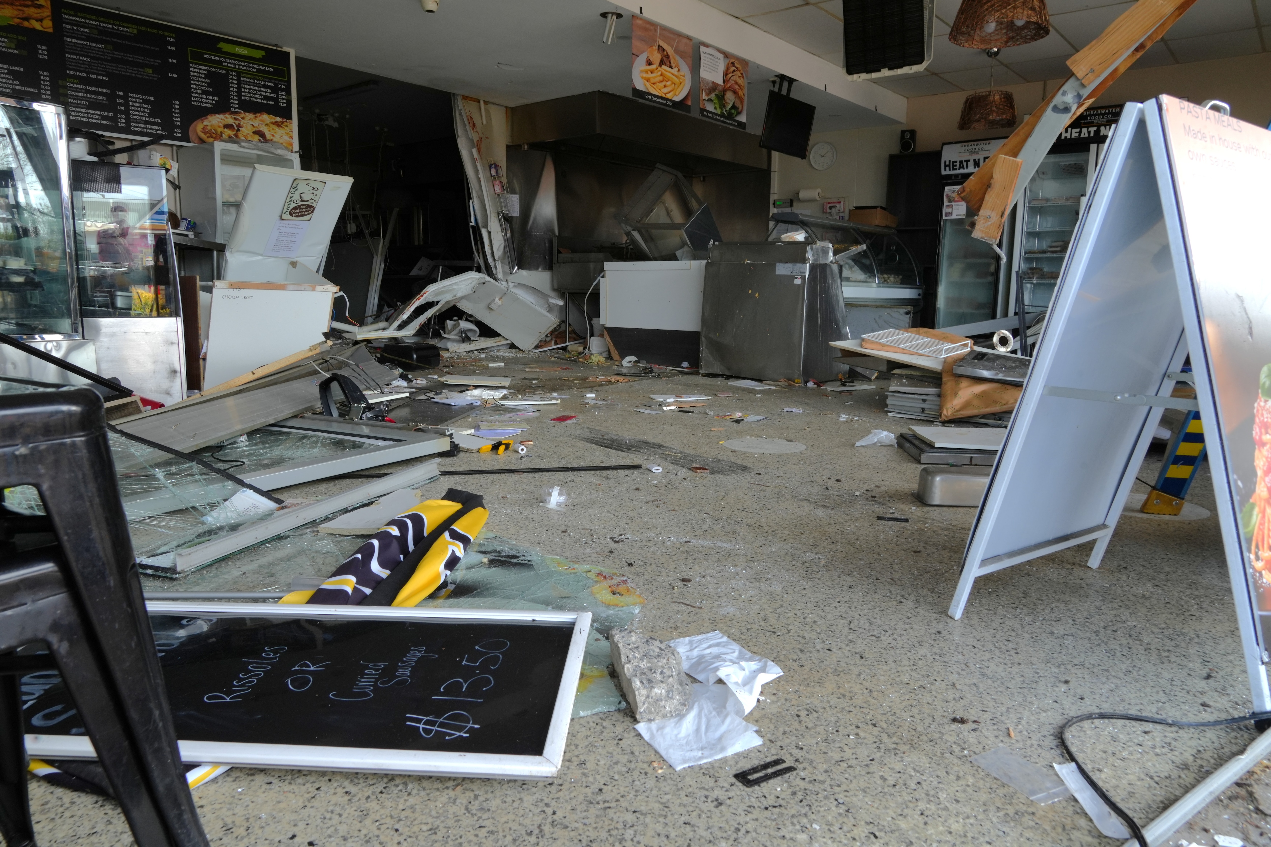 Damage to cafe business after car smashed through front wall.