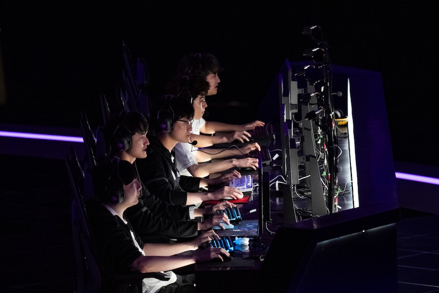 Taiwanese esport players sit at their screens during the final.