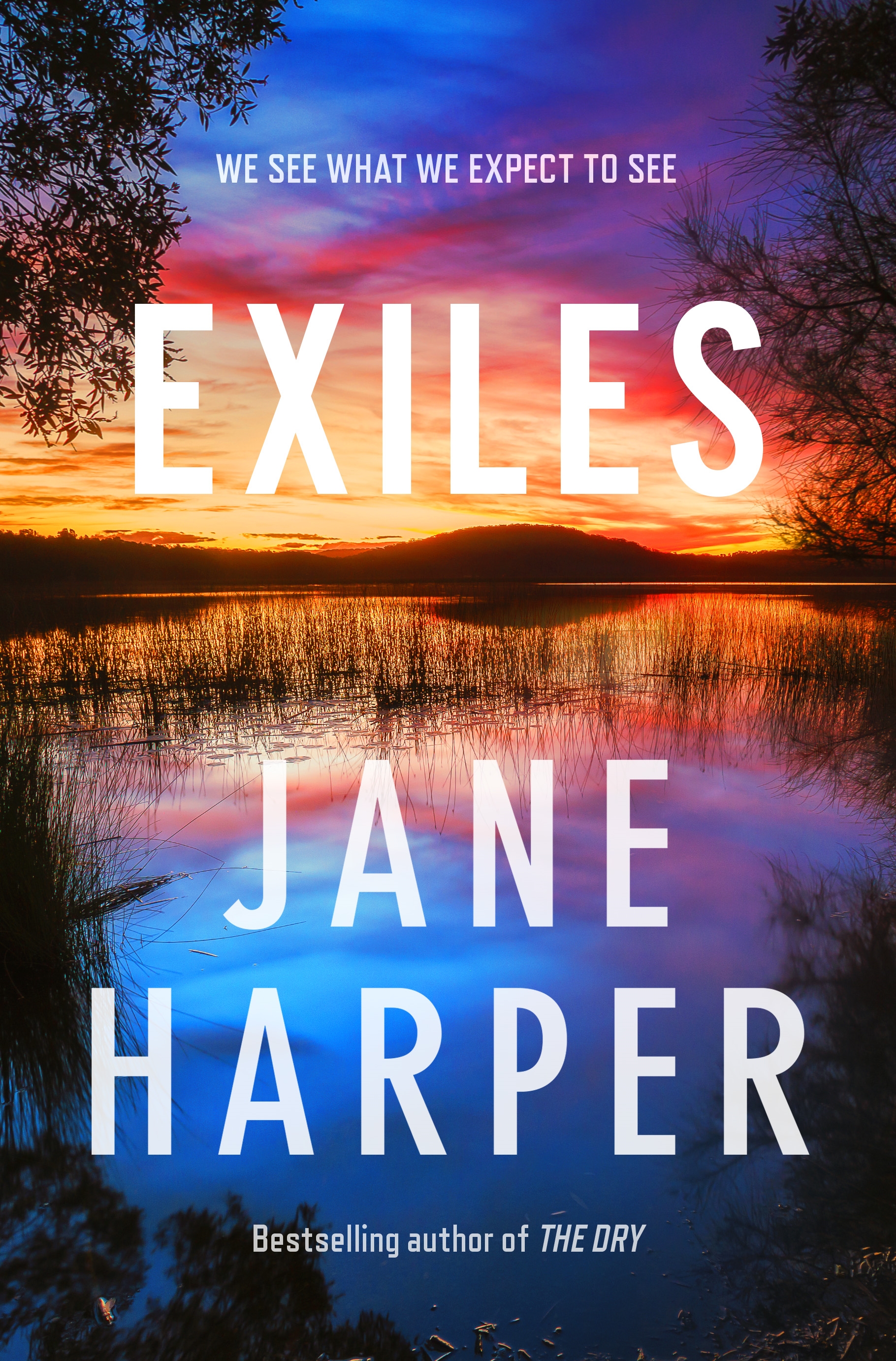 A book cover showing a lake at sunset, with vivid blue, yellow and pink sky reflected on the water