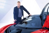 Andrew Flintoff standing next to a red sports car for a promotional shoot for Top Gear