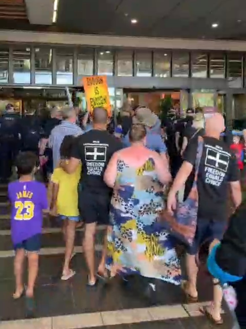 A group of people outside a shopping centre