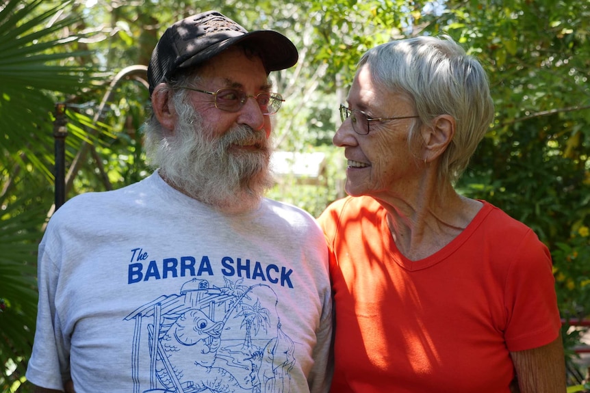 Older couple staring at each other smiling.