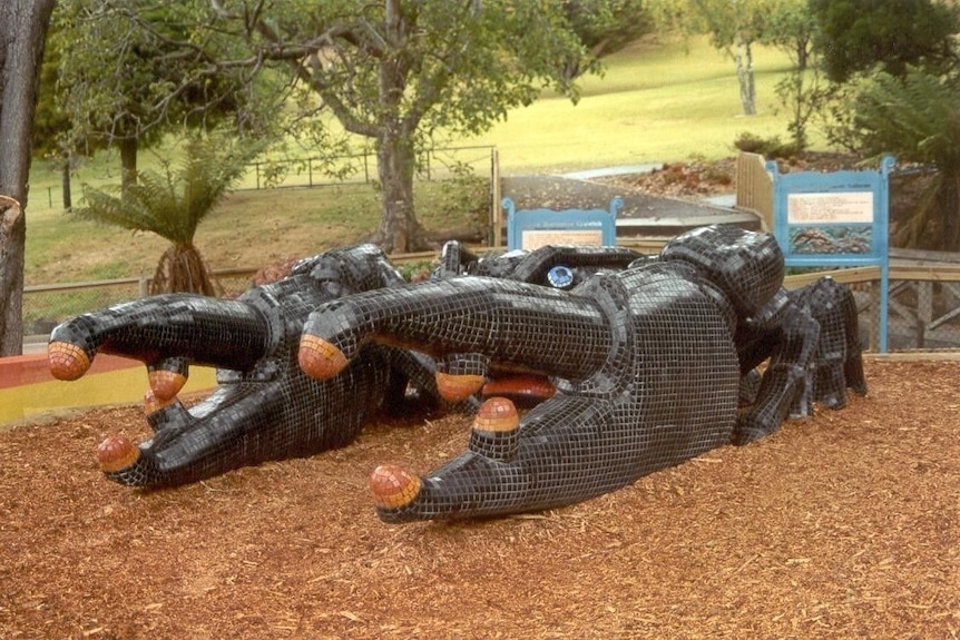 A large black, shiny mosaic sculpture of a freshwater cray fish