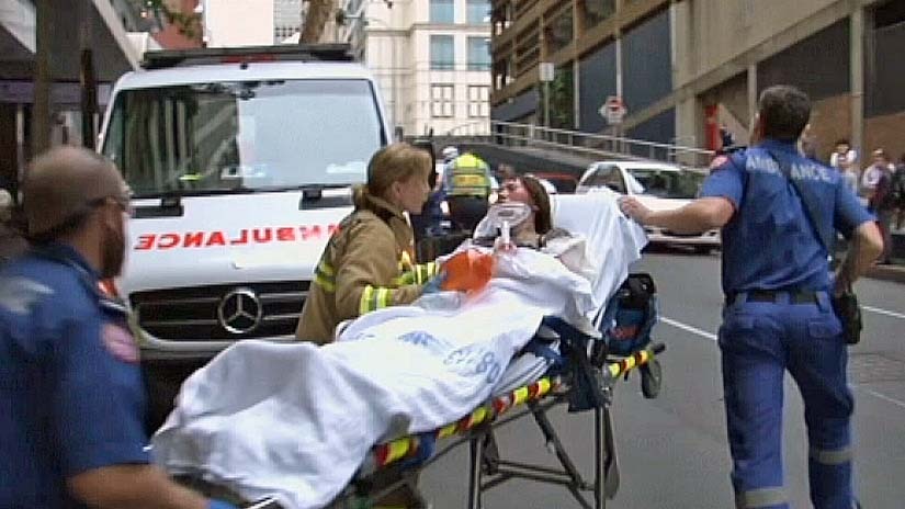 Paramedics treat woman for burns in Castlereagh St Sydney