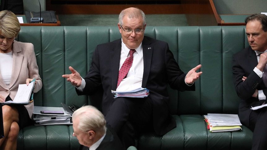 Morrison has his arms raised as if he doesn't know what's going on.