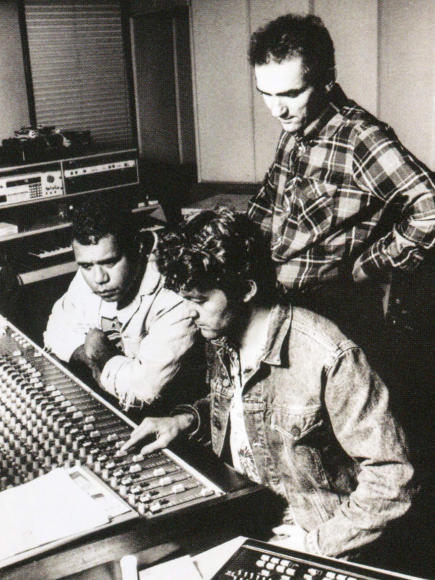 Archie Roach and engineers at a mixing desk.