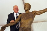 Former AFL player and coach Malcolm Blight with his statue in Adelaide.