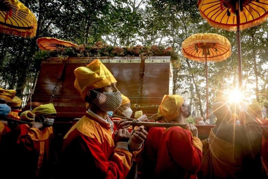 Thich Nhat Hanh's casket begins its journey as dawn breaks in Hue, Vietnam.