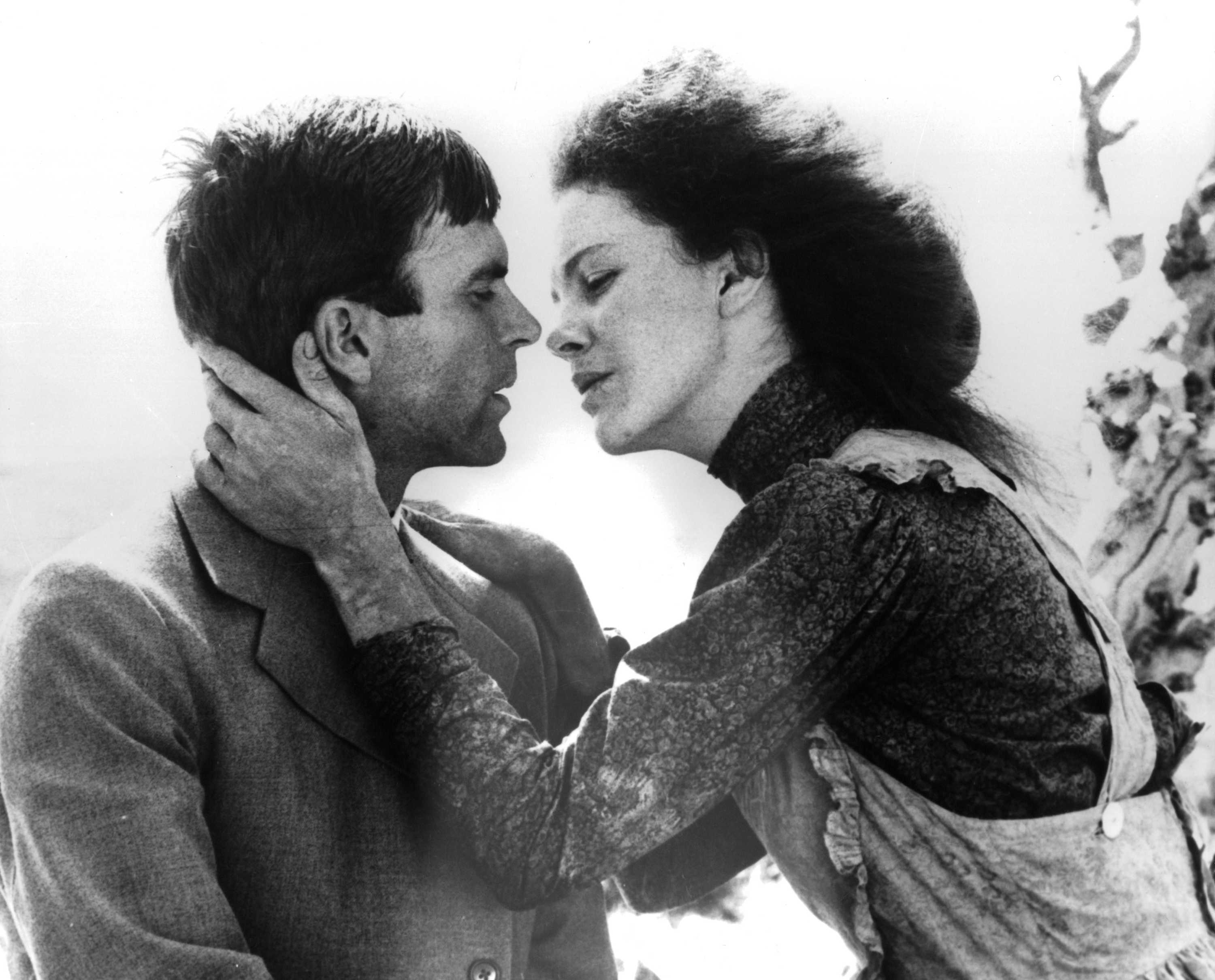 A black and white still of Judy Davis embracing Sam Neill.
