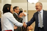 Prime Minister Anthony Albanese shakes hands of Labor members of parliament at the first caucus meeting since the election.