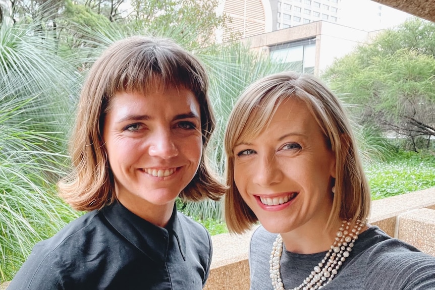 two women standing in a garden