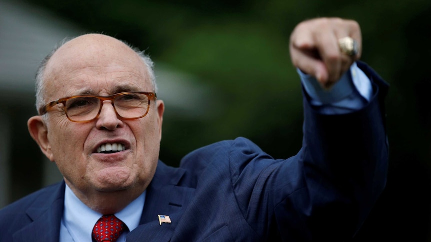 Rudy Giuliani points finger down.