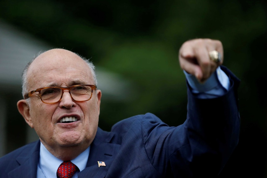 Rudy Giuliani points finger down.