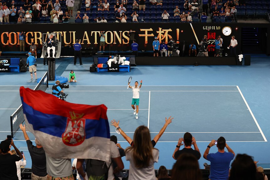 Novak Djokovic holds up his hands to the crowd