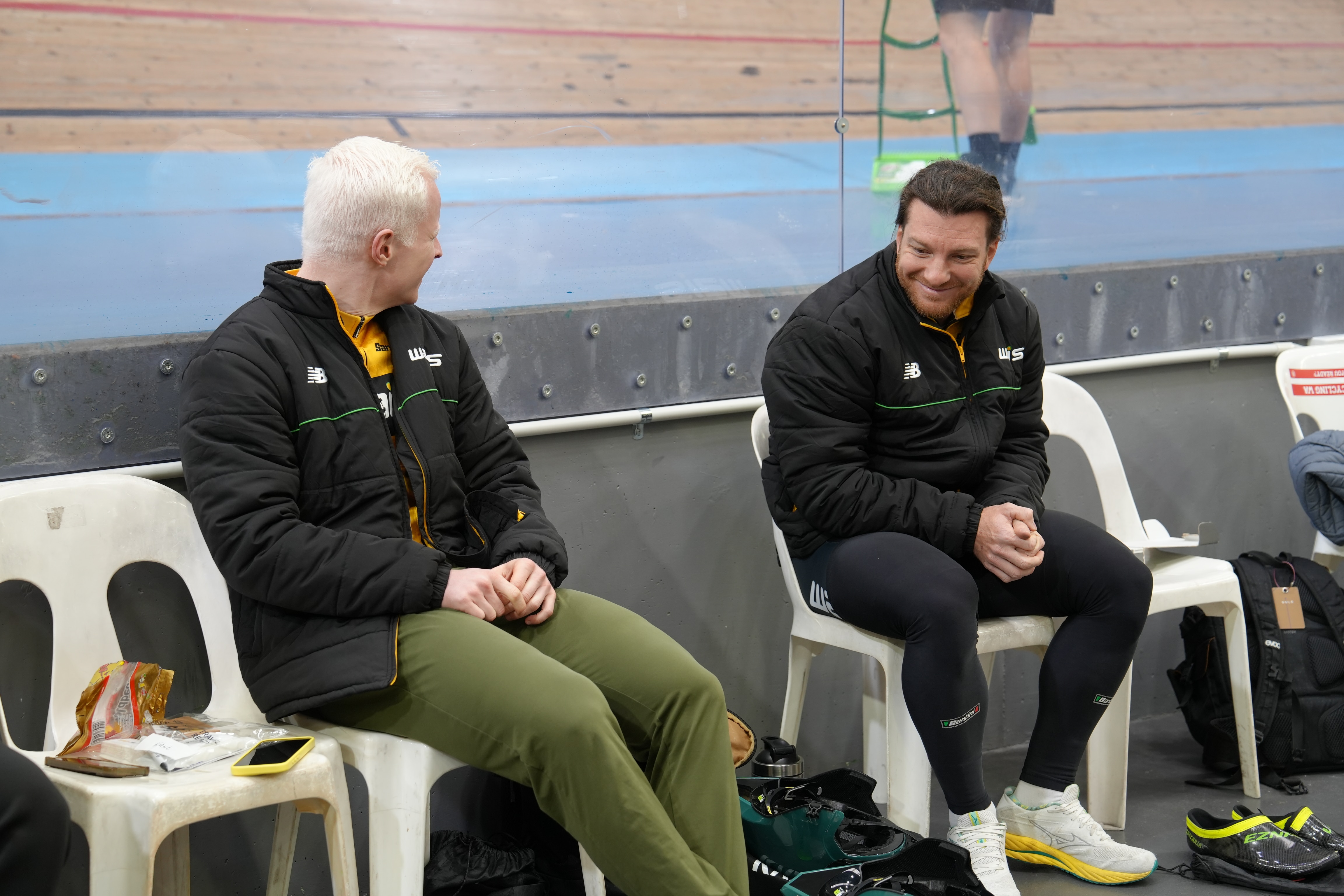 Cyclists Luke Zaccaria and Kane Perris sit chatting after training.