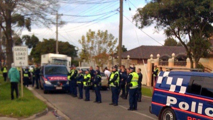 Police form a barrier outside the Chaouk house in Brooklyn, in Melbourne's west