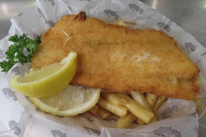 Cooked fish and chips with lemon