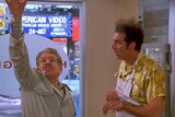 Frank Costanza gestures upward as Kramer looks on
