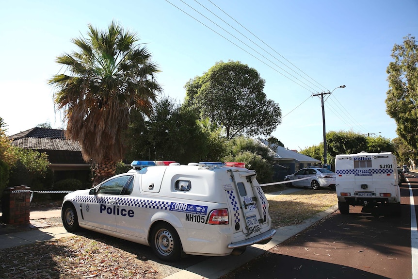 Three police vehicles outside a suburban house on a sunny morning.