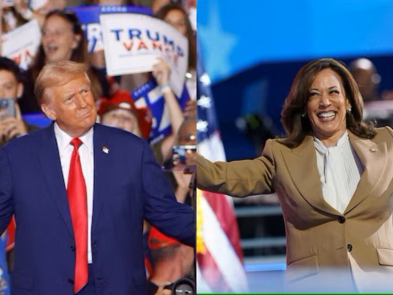 A man in a blue suit and red tie and a woman in a camel-coloured suit and white shirt