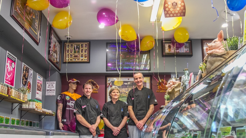 Butchers Matt Roberts, Renee Wood and Dave McGuirk are getting into the grand final spirit in Brisbane.
