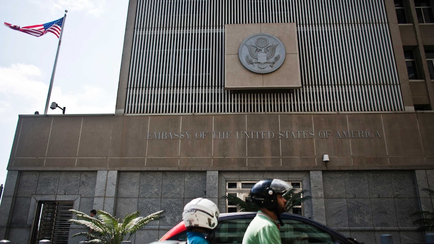 Motorists drive past the US embassy in Tel Aviv.