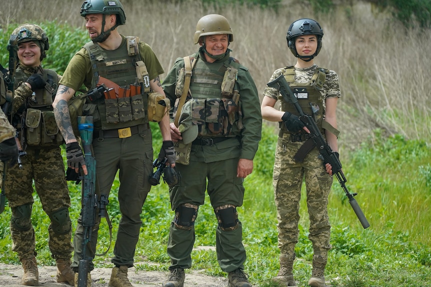 A group of soldiers in combat gear holding big rifles 