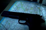Gun laid down on map