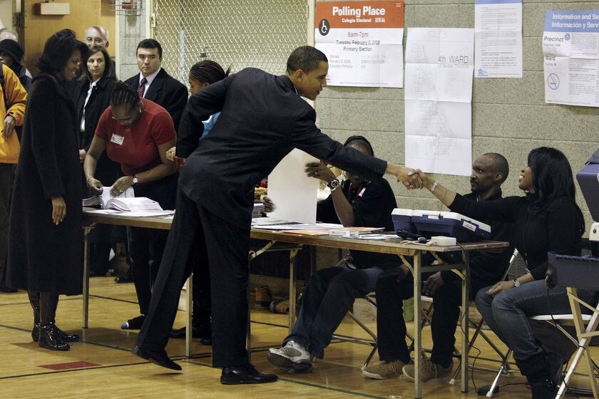 Barack Obama greets election workers before voting