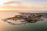 An aerial view of the city of Darwin at sunset.