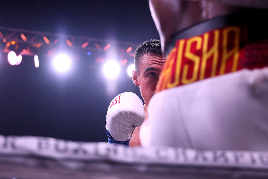 Tim Tszyu peeks out from behind Terrell Gausha's shorts