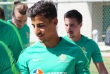 Daniel Arzani walks off the field with his teammates after training in Turkey.