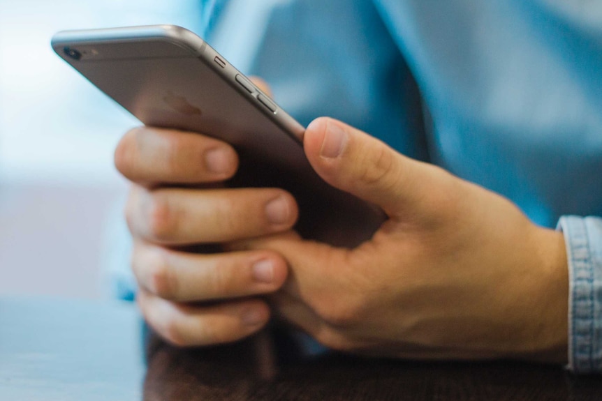 A man holding a mobile phone.