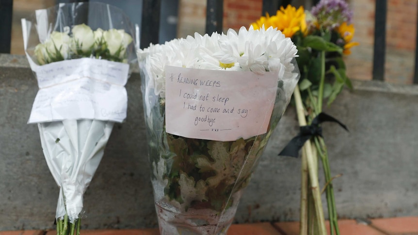 Floral tributes left by the Abbey gateway of Forbury Gardens a day after a multiple stabbing attack in the gardens in Reading, England