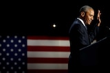 US President Barack Obama holds up his hand as he delivers his farewell address in Chicago, Illinois.