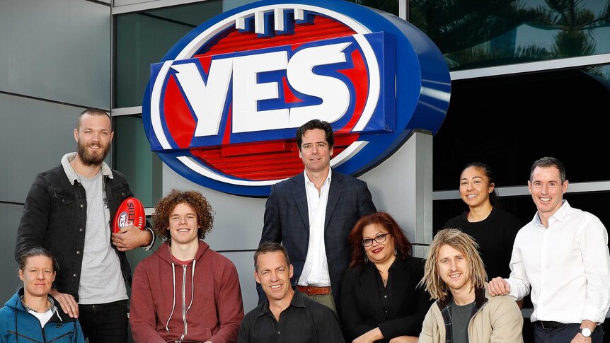 Players and AFL chief executive Gillon McLachlan stand around the AFL's Yes logo, in support of same-sex marriage.