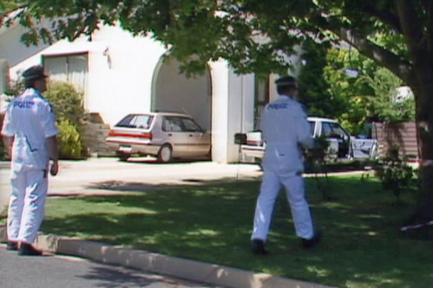 Police look for evidence at the murder scene of Colin Winchester at Deakin in January 1989.