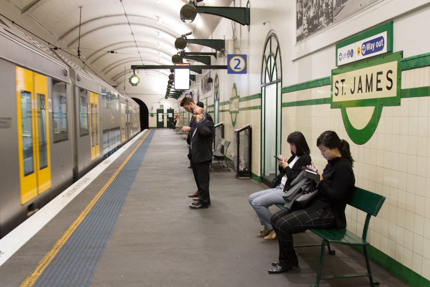 Commuters wait on platform 2 of St James station